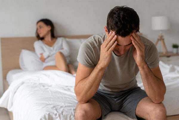Erectile Dysfunction: Causes, Symptoms, Diagnosis, Treatment & Prevention 5 Man experiencing Erectile Dysfunction with emotional stress and relationship concerns in a bedroom setting