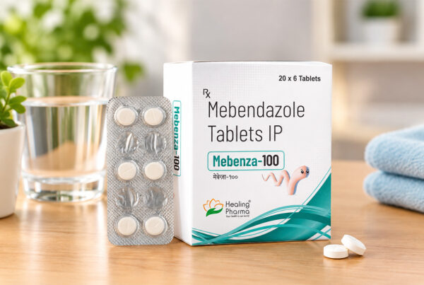 Mebenza 100 mg Tablet: Uses, Dosage, Benefits, Side Effects & Safety Guide 5 Mebenza 100 mg Tablet box and blister pack with water on a wooden table